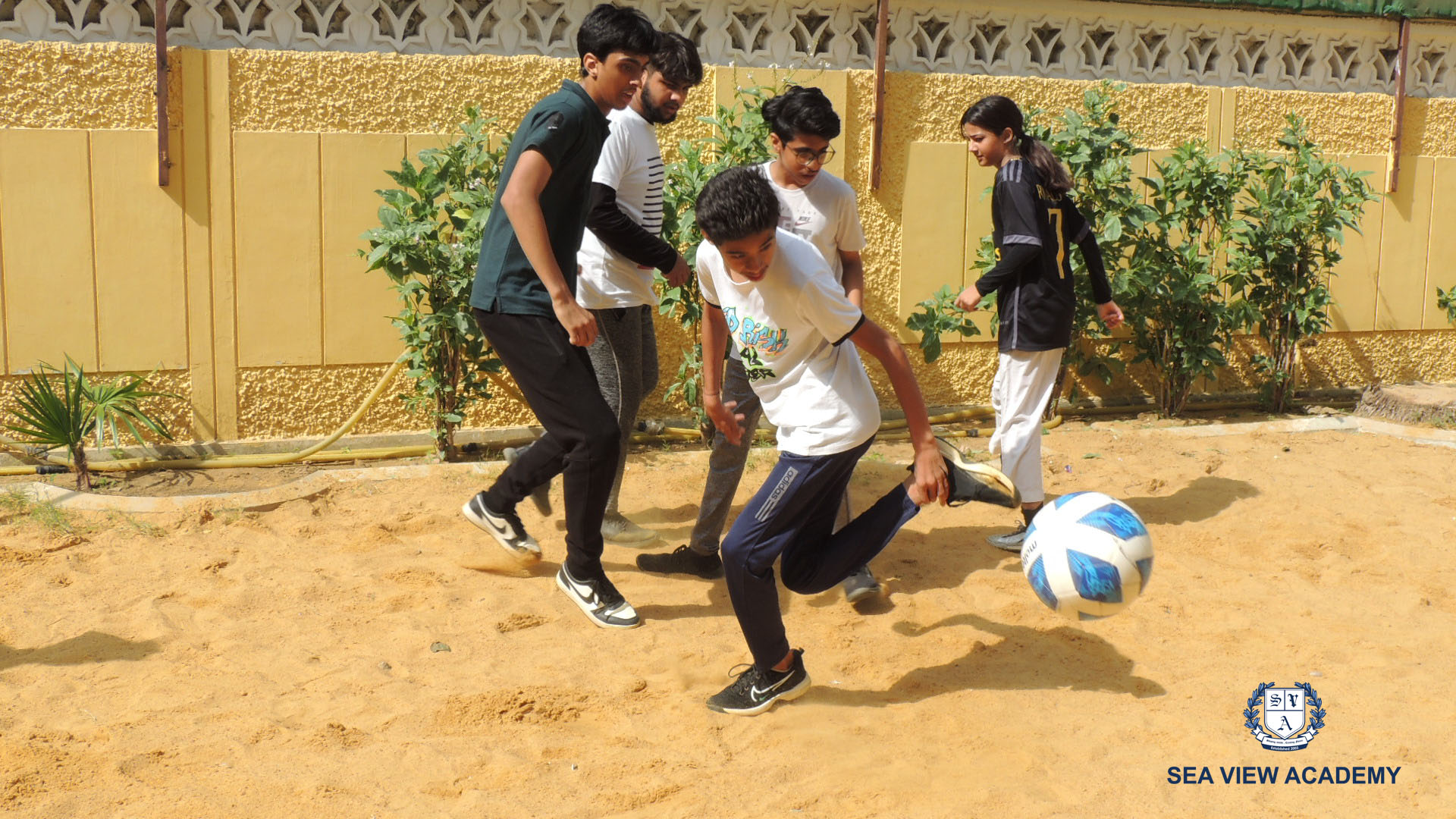 Students playing football on the school ground